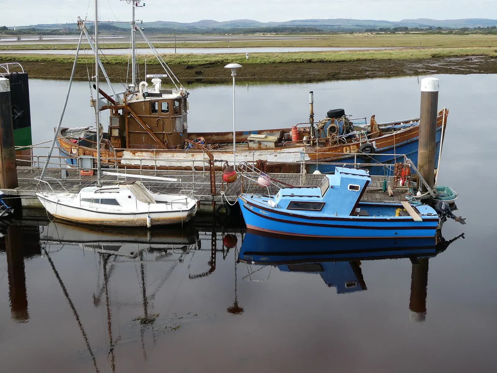 Boats moored at Irvine harbour, with the estuary behind them